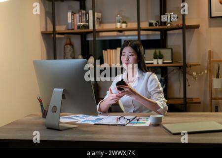 The young woman is working late into the night Stock Photo