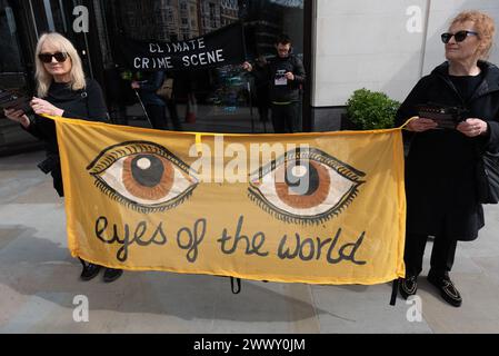 London, UK. 26 March, 2024. Extinction Rebellion activists protest outside the London HQ of fossil fuel company Perenco UK in Hanover Square to mark the 1st anniversary of an oil spill in Poole Harbour, Dorset, for which the company was responsible. 200 barrels of oil escaped from Wytch Farm oil field into the harbour, a site designated of Special Scientific Interest due to its environmental importance. Credit: Ron Fassbender/Alamy Live News Stock Photo