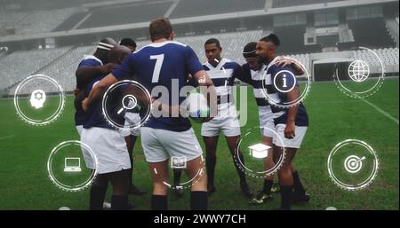 Image of media icons over diverse male rugby team in huddle at stadium. Sport, team, competition, social network, digital interface, internet and comm Stock Photo