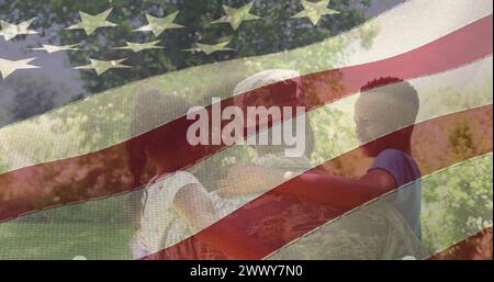Image of male soldier embracing smiling daughter and son over american flag. soldier returning home to family concept digitally generated image. Stock Photo