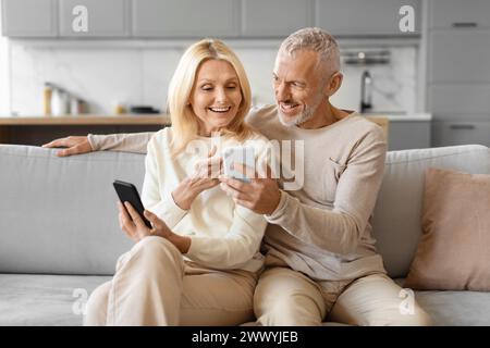 Happy senior couple using smartphone Stock Photo