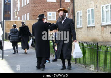 London, UK. 24th Mar, 2024. Orthodox men dressed in costumes take part in the annual festival of Purim on the streets of Stamford Hill in north London. Purim festival is celebrated by Jewish community around the world, commemorating it, when Jewish people were saved from Haman. It is a joyous annual festival where children dress in fancy costumes, friends and family, feast, rejoicing and exchanging food. (Photo by Steve Taylor/SOPA Images/Sipa USA) Credit: Sipa USA/Alamy Live News Stock Photo