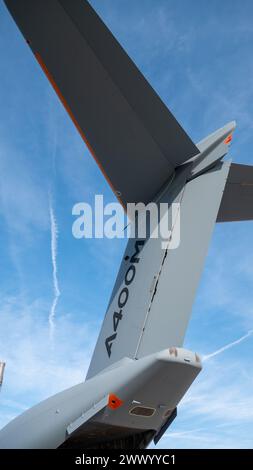 A vertical low angle shot of an A400M plane tail under a blue sky Stock Photo