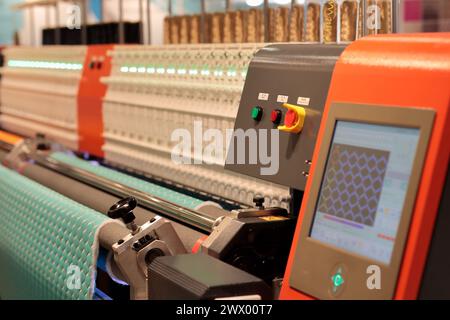 Computerized automatic double head multi needle quilting machine. Selective focus. Stock Photo