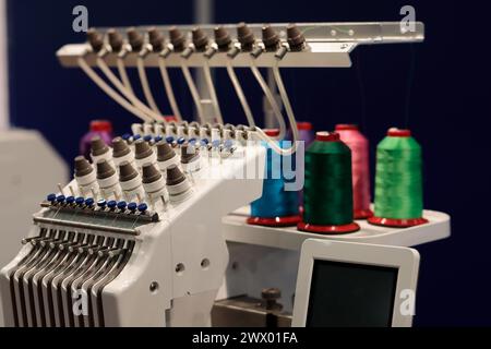 Modern embroidery machine with touch control panel. Selective focus. Stock Photo