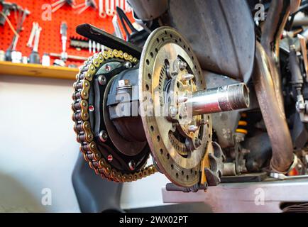 Motorcycle brake and  system, disc. caliper rim and chassis, repair time at workshop Stock Photo