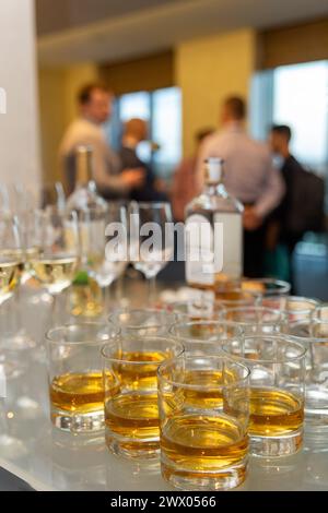 A lot of glasses with scotch, brandy and whine stand on the bar. Various alcoholic beverages in glasses at buffet on party. Vertical shot. Stock Photo