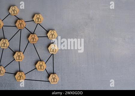 Wooden blocks connected with arrows. Each wooden block has a icon of a person. Networking concept. Copy space for text. Stock Photo