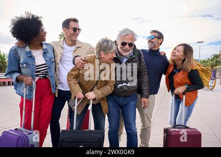 Group mid aged excited tourist friends having fun and laughing together on trip  Stock Photo