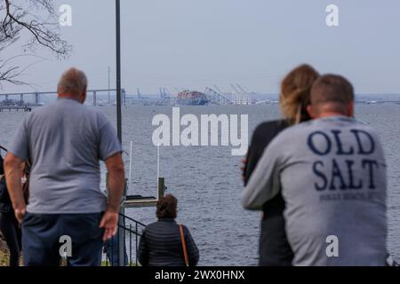 Baltimore, United States Of America. 26th Mar, 2024. Onlookers view rescue efforts by authorities, as they search for people trapped under the remains of Francis Scott Key Bridge outside Baltimore, Maryland after a container ship lost power and struck the bridge in the early morning hours on Tuesday, March 26, 2024. Credit: Aaron Schwartz/CNP/Sipa USA Credit: Sipa USA/Alamy Live News Stock Photo