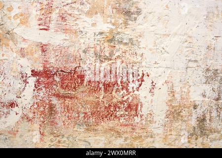 The tonal range from red to pink to cream of this background wall is offset by the deeply textured medium of cement. Stock Photo
