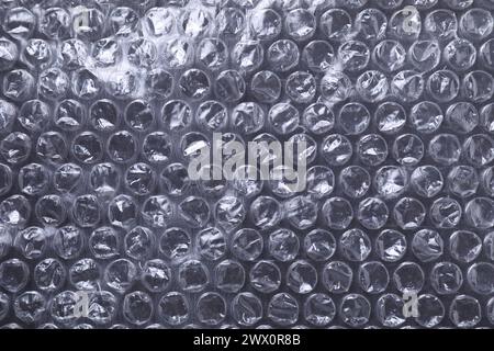 Transparent bubble wrap on black background, top view Stock Photo