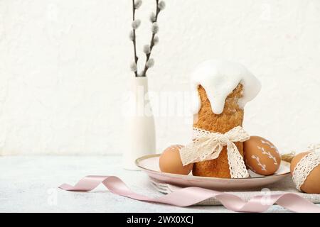 Plate with Easter cake, eggs and willow branches on white background Stock Photo