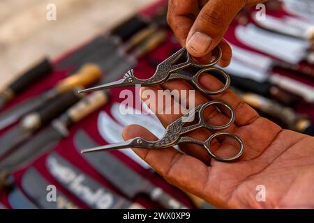 The master showing the scissors made by him , Bukhara, Uzbekistan Stock Photo