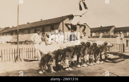 WAR PRISON BARRACKS NO. 1, FT. MCPHERSON, GA. Gymnastics. A jump over 10 men ca. 1918-1919 Stock Photo