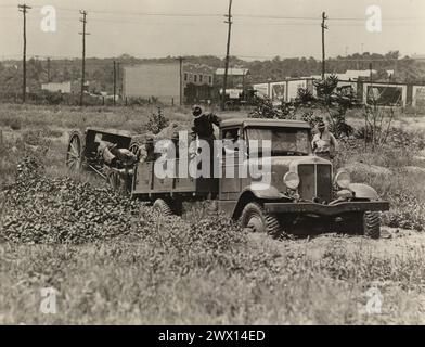 4 1/2 ton, 4 wheel, 4 wheel drive, Qm. C. designed and constructed vehicle, negotiating hazardous terrain towing a 155mm howitzer ca. probably 1925-1935 Stock Photo