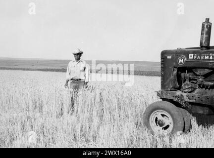 Man in Field in Wyoming with McCormick-Deering Farmall Tractor ca. 1934-1946 Stock Photo