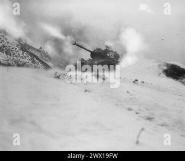 Near Song Sil-li, Korea, a tank of 6th Tank Battalion, fires on enemy positions in support of the 19th Regimental Combat Team ca. January 1952 Stock Photo