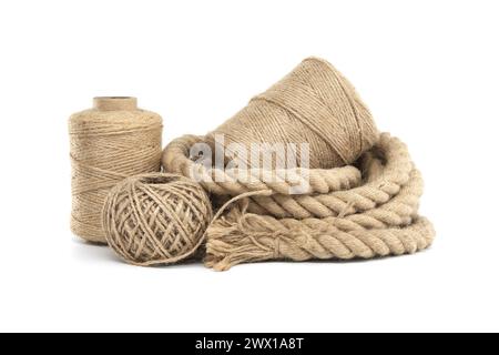 Collection of various rolls of natural jute rough rope and twine arranged on a white surface Stock Photo