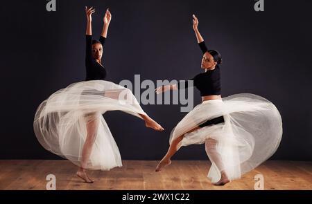 Ballet, black people and ballerina in studio for dance routine, spinning and creative performance. Contemporary, dancing and young women for elegant Stock Photo