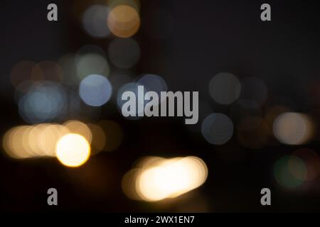 Blurred bokeh city lights, abstract night scene. Abstract high resolution full frame background with copy space. Stock Photo