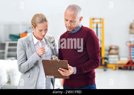 Retail, clipboard or business people in warehouse for cargo checklist, brainstorming or planning delivery logistic. Supply chain, documents or factory Stock Photo