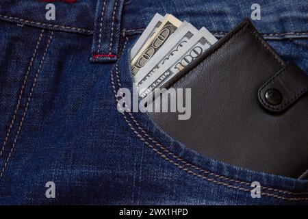 purse with money in the pockets of jeans pants Stock Photo
