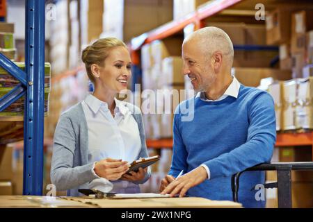 Teamwork, collaboration and employees at warehouse for logistics, inventory and discussion in meeting for ecommerce industry. Workers, man and woman Stock Photo