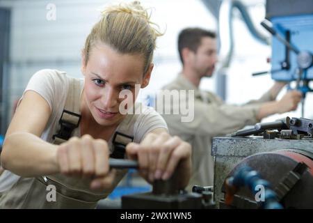 a tired female metal working worker Stock Photo