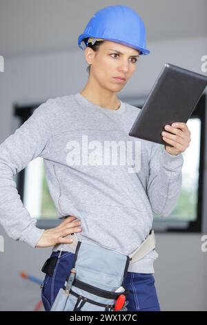 female construction worker watching tablet Stock Photo