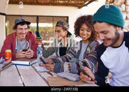 Diverse students, gen z and social media for university project using smartphone for research, networking and discussing college people. Group work Stock Photo