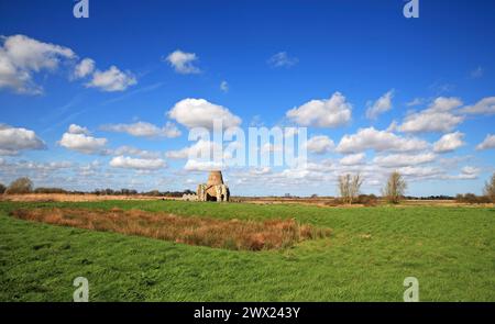 A landscape by the River Bure on the Norfolk Broads featuring the ruined gatehouse and old mill at St Benet's Abbey, Horning, Norfolk, England, UK. Stock Photo