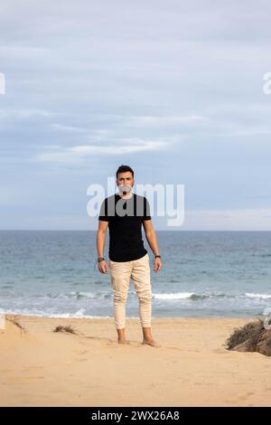 Barefoot man walking on the beach in the desert Stock Photo