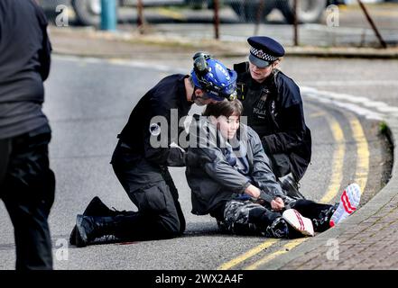 Sandwich, UK. 26th Mar, 2024. An activist is pulled into an upright position after refusing to walk when getting arrested during a demonstration outside Instro Precision. Instro Precision provide components for Elbit Systemís weaponry. Palestine Action continues to target subsidiary companies of Israeli arms company Elbit Systems in an attempt to isolate them and make business impossible. This tactic has caused two of Elbit's ten main businesses to close in the UK and several partner companies to cut ties with them. Credit: SOPA Images Limited/Alamy Live News Stock Photo