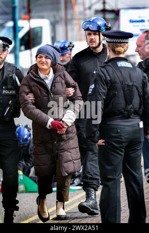 Sandwich, UK. 26th Mar, 2024. An activist is arrested and led away in handcuffs after being removed from a lock-on outside Instro Precision during a demonstration. Instro Precision provide components for Elbit Systemís weaponry. Palestine Action continues to target subsidiary companies of Israeli arms company Elbit Systems in an attempt to isolate them and make business impossible. This tactic has caused two of Elbit's ten main businesses to close in the UK and several partner companies to cut ties with them. Credit: SOPA Images Limited/Alamy Live News Stock Photo