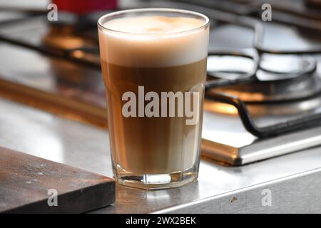 A cup of coffee standing on a bar desk. Stock Photo