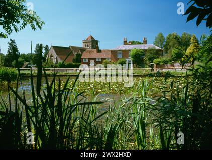 Chiddingfold, The Green, Haslemere, Surrey, LSW across pond to church and cottages. 19 July 1990 Stock Photo