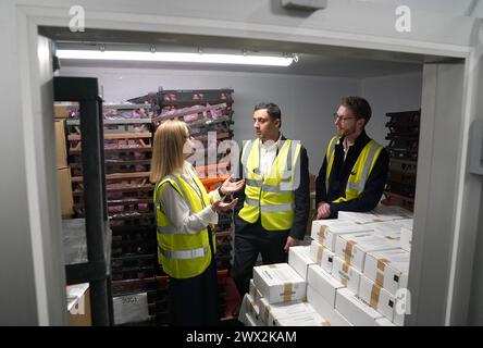 Scottish Labour leader Anas Sarwar and Chris Murray, Labour party candidate for Edinburgh East and Musselburgh are shown a freezer storage area by Lynne Collie, senior manager enterprise at Cyrenians during a visit to Cyrenians homelessness charity in Edinburgh to learn more about how they support those in need. Picture date: Wednesday March 27, 2024. Stock Photo