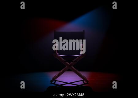 Cinema Industry Concept. Back of Director Chair in Spotlight Lights on a black background. 3d Rendering Stock Photo