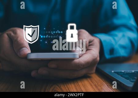 Cyber security. Business, technology, internet and networking concept. Young business man working on his laptop in the office, select the icon securit Stock Photo