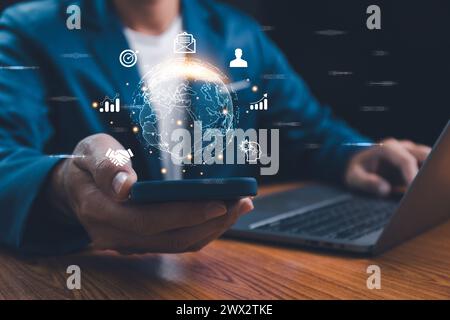 Businessman holding smartphone with virtual Global Internet connection. Global internet connection application technology and digital marketing, Finan Stock Photo