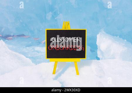 Customer onboarding symbol. Concept words Customer onboarding on beautiful yellow black blackboard. Beautiful blue ice background. Business Customer o Stock Photo