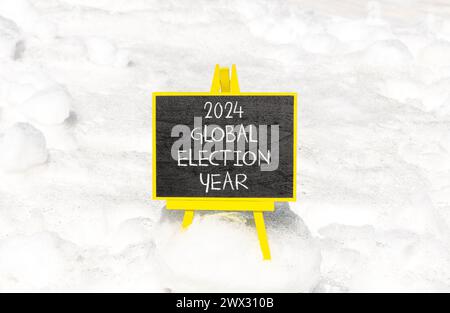 2024 global election year symbol. Concept words 2024 global election year on beautiful black chalk blackboard. Beautiful white snow background. Busine Stock Photo