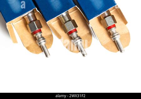 New modern ceramic glow plugs in packaging on a white background. Concept for replacing glow plugs in cold weather. Automotive part Stock Photo