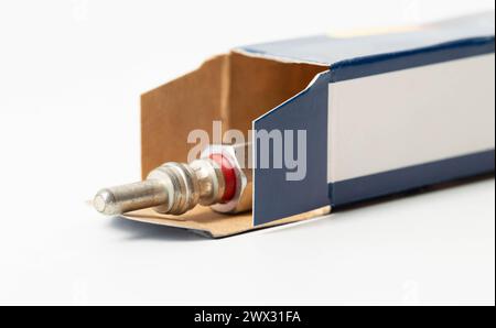 New modern ceramic glow plugs in packaging on a white background. Concept for replacing glow plugs in cold weather. Automotive part Stock Photo