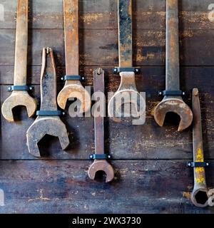 Display of old wrenches on a wooden background. Stock Photo