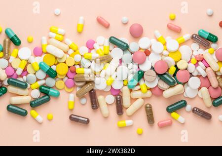 Many different pills on pink background. Prescription pills and vitamins. Flat lay and space for text Stock Photo