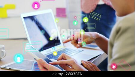 Image of profile icons and message boxes over caucasian female coworkers analyzing reports. Digital composite, multiple exposure, business, planning, Stock Photo