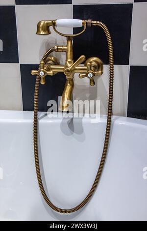 Old fashioned goldenfaucet in the bathroom Stock Photo