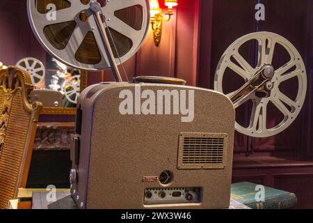 Vintage old projector with tape in the dark room in the house Stock Photo